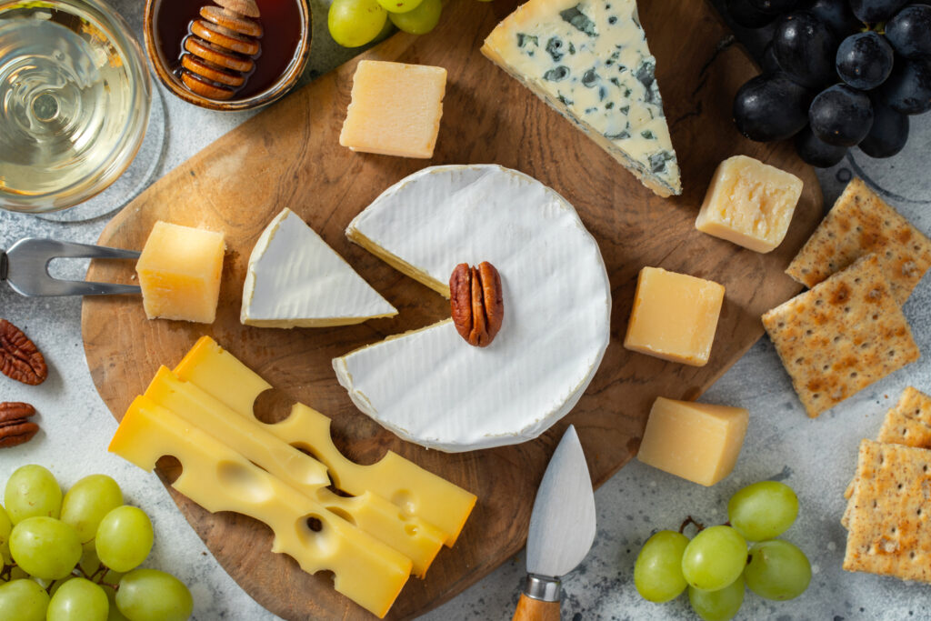 cheese and wine party ideas - tasting cheese on a wooden plate