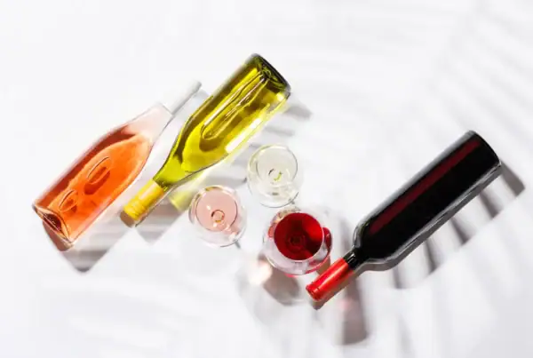 three wine glasses filled with red, white and rose