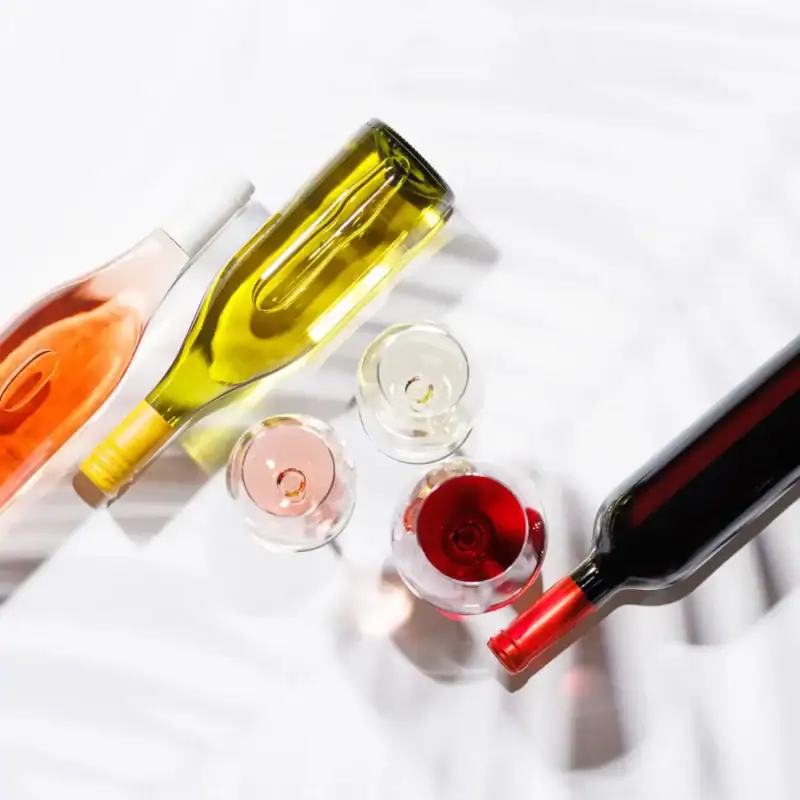 three wine glasses filled with red, white and rose